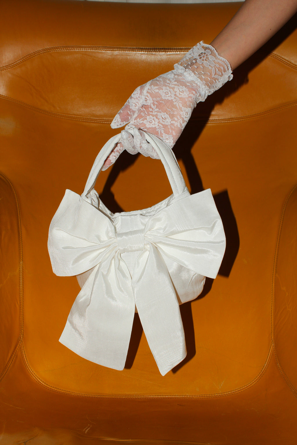 A Bronze Age Sammy Bag with Bow, Top Handle Evening Handbag | Made